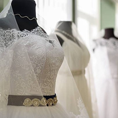 Elegant Wedding Dresses Displayed on Mannequins in Luxurious Bridal Salon.